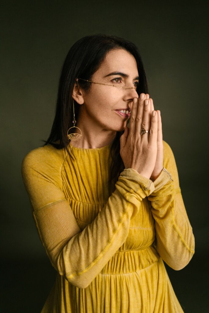 Janelle Marie with her hands in front of her face