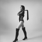 Janelle Marie holding a flogger