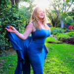 Shari James in a blue dress out in nature