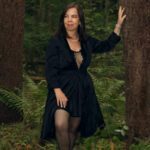 Ella Rose dressed in black in nature