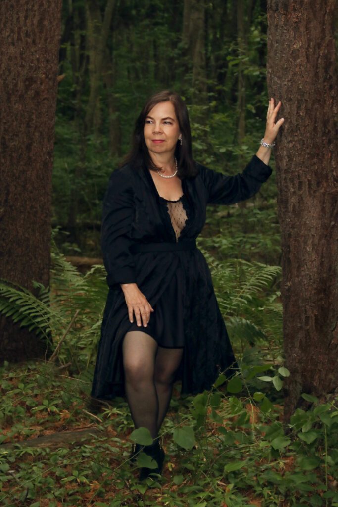 Ella Rose dressed in black in nature