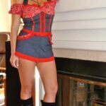 Sheeva dressed up standing next to a fire place