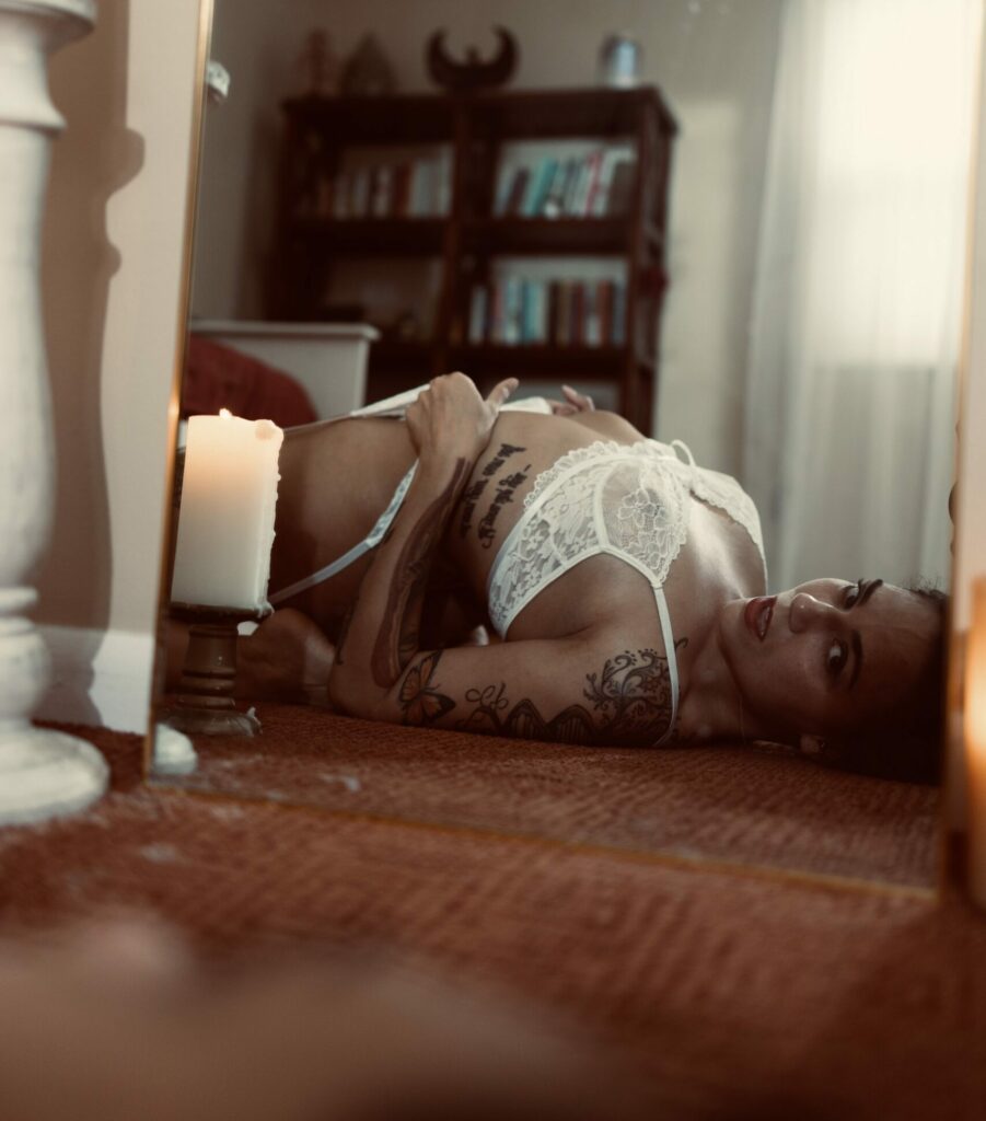 Gina Marie dressed in white lingerie laying on the floor