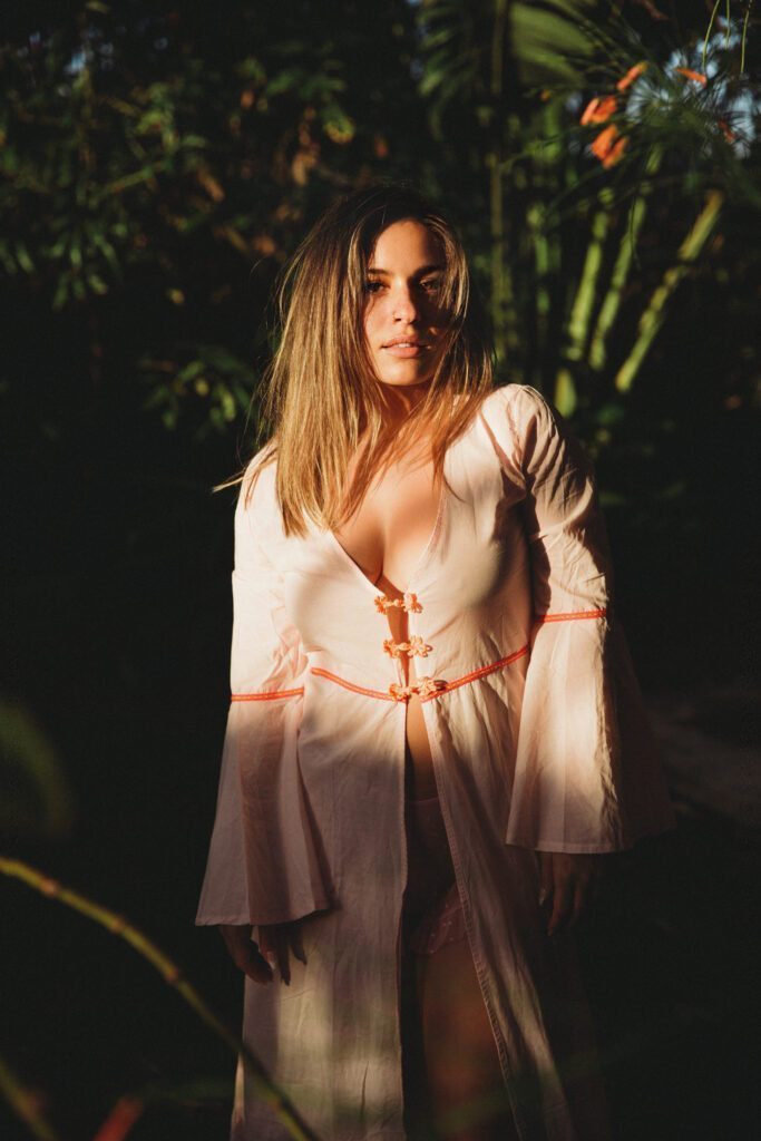 Emma Raven ina white dress adn shaded