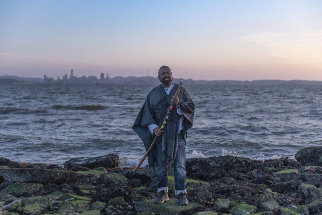 Tevita Kaukauwa standing in front of the sea