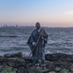 Tevita Kaukauwa standing in front of the sea