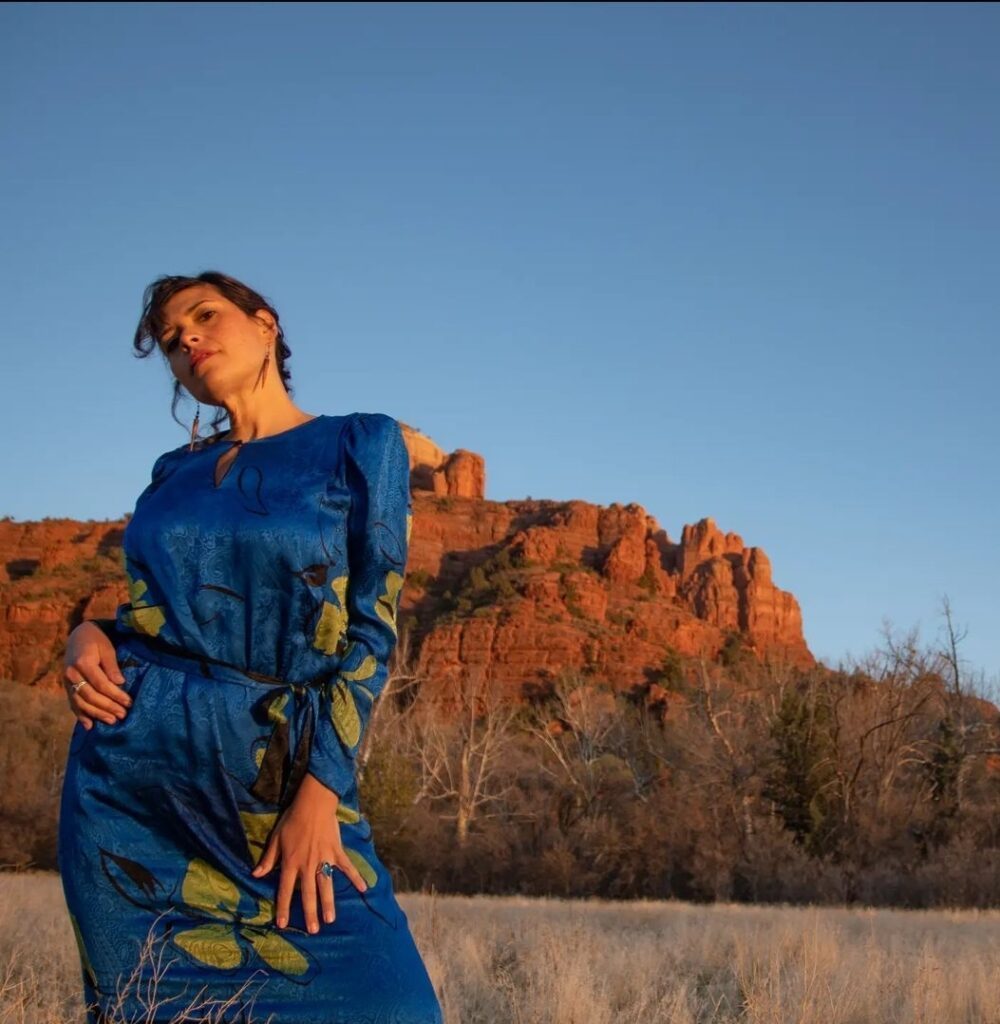 Ishtar Andara posing in a blue dress