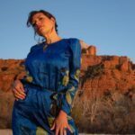 Ishtar Andara posing in a blue dress