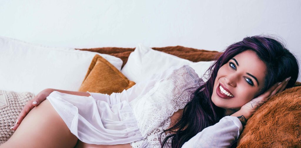 Laying on a bed in a white shirt