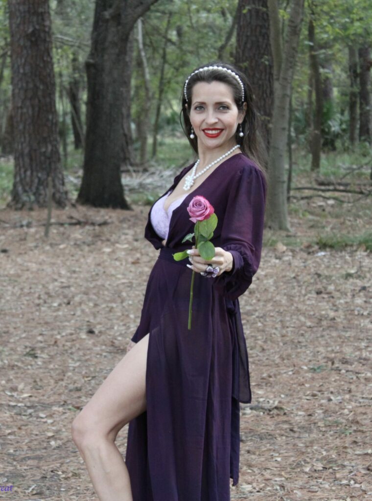Nohami in the woods holding a rose.