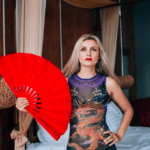 Rina Trevi holding a fan