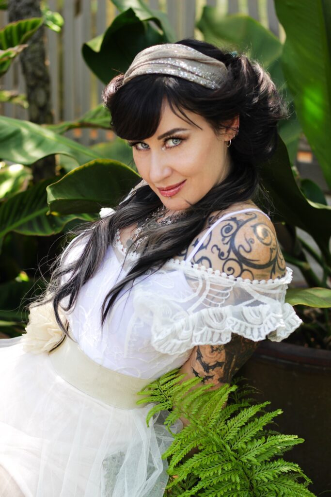 Kat V in a white dress