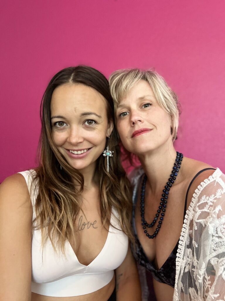 Lila and Olivia close-up with a pink background.