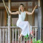 Nathalia sitting on some wood