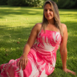 Andrea sitting on the grass in a pink dress