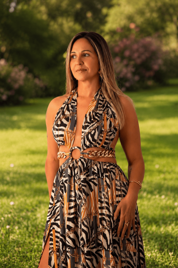 Andrea in a park wearing a long black-white patterned dress