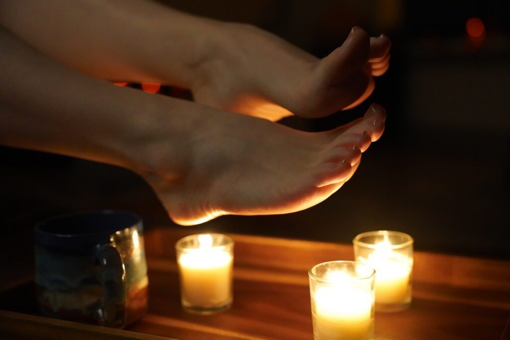 Her feet over some candles