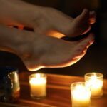 Her feet over some candles