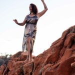Yulia Rose standing on some roacks