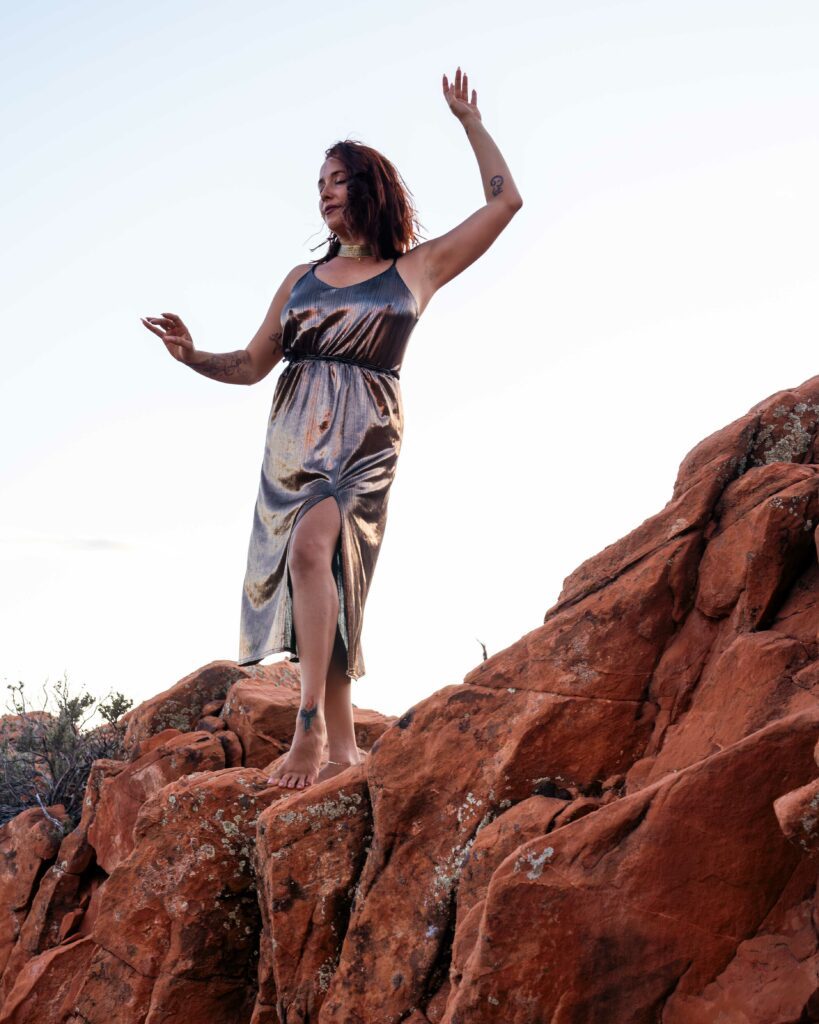 Yulia Rose standing on some roacks