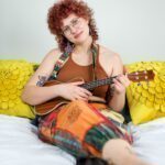 Pleasure Sage playing the guitar