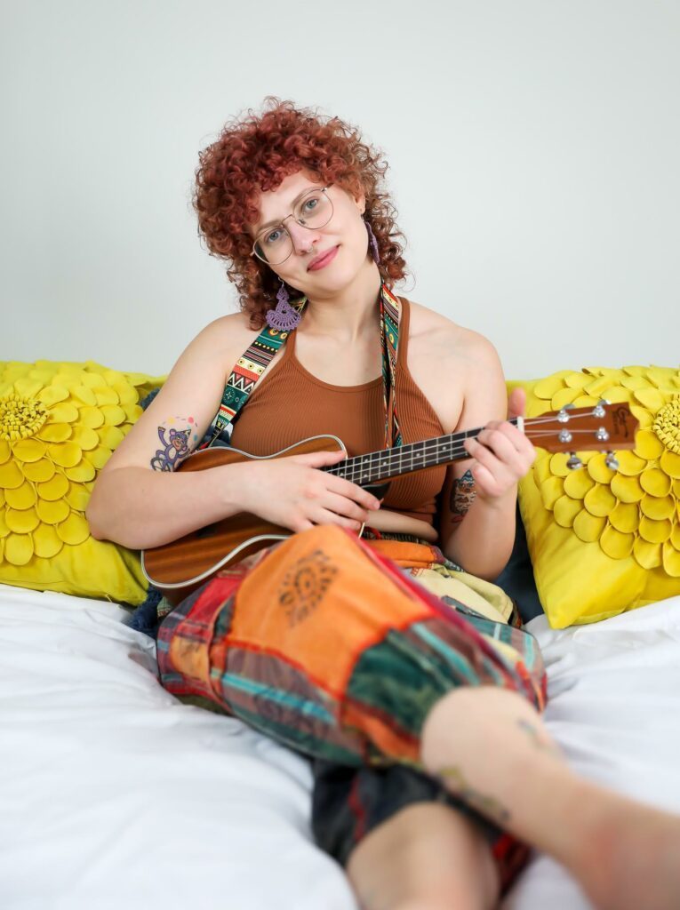 Pleasure Sage playing the guitar