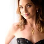 Mara next to a window in lingerie