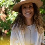 Vixen with a big smile wearing a straw hat.