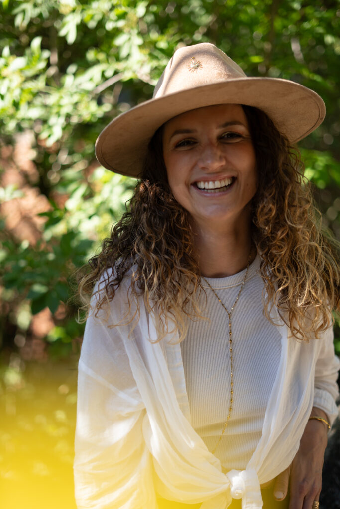 Vixen with a big smile wearing a straw hat.