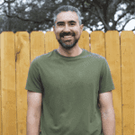 Adam with a big warm smile in casual clothing.