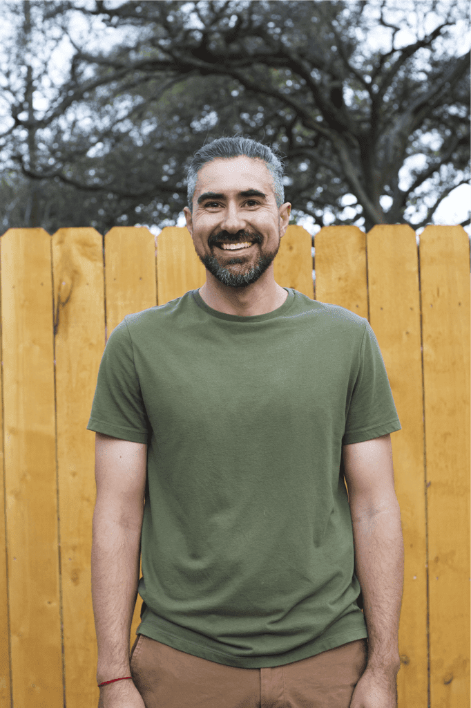 Adam with a big warm smile in casual clothing.