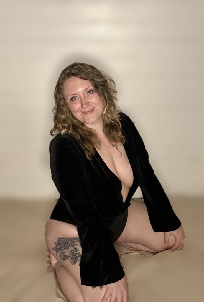 Priestess Seriph sneeling on the floor and smiling to the camera.