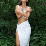Mukti embracing herself in the forest.