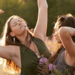 Hannah and Mahina dancing on a meadow.