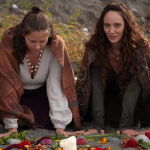 In the nature. Hannah and Mahina kneeling down by an altar.