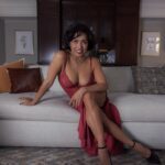 Sitting on a sofa with a beautiful red dress