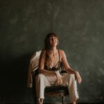 Samantha sitting on a chair and laughing.