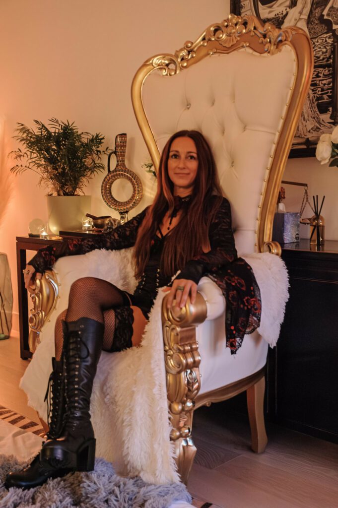 Dr Seva sittting on a huge fancy armchair.