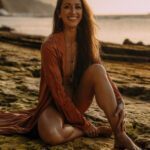 Dr Seva on the beach with a warm inviting smile.