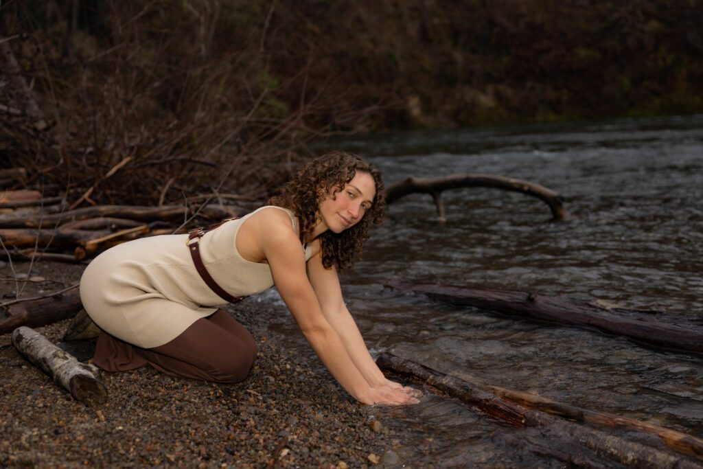 Putting her hands in the river