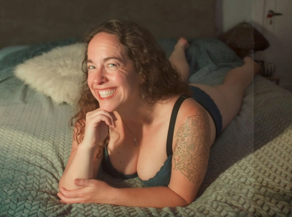 Ravi on the bed in lingerie.
