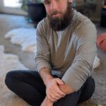 Shot of Michael sitting on a cozy carpet.
