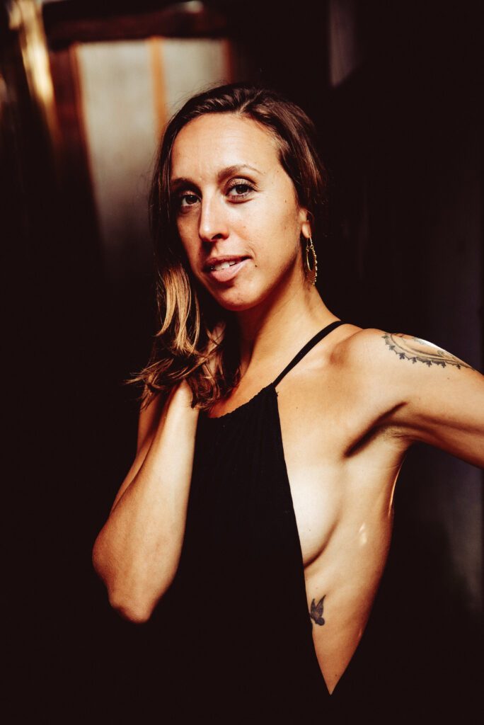 Portrait shot of Joy Shakti wearing a black top.