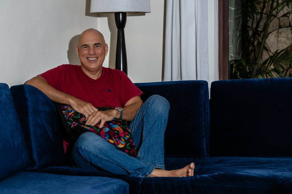 Phil on the couch with a big smile.