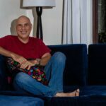 Phil on the couch with a big smile.