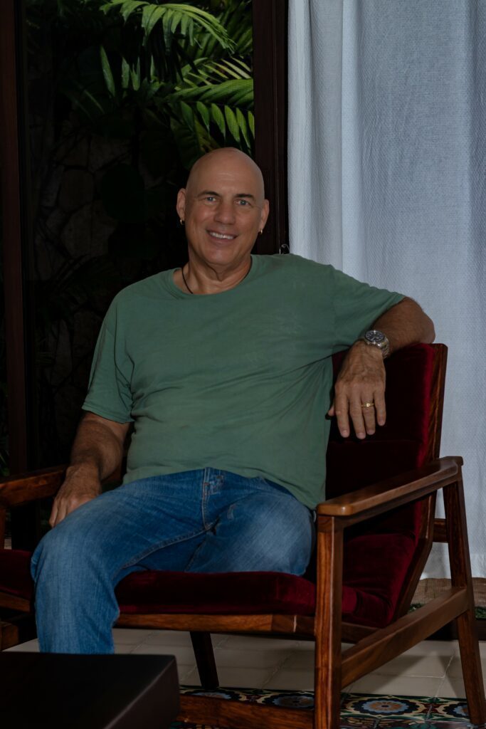 Sitting on an armchair and smiling