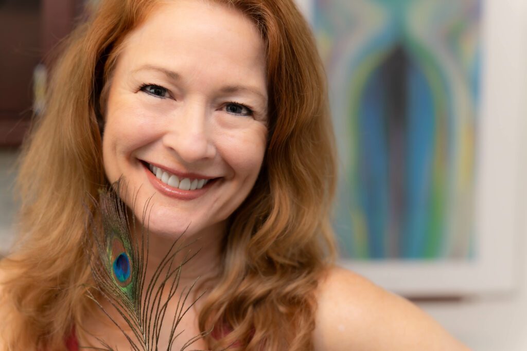 Close-up of Kim with a peacock feather.