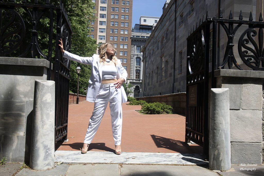Metal gates in the city. cassy at the entrance in white.