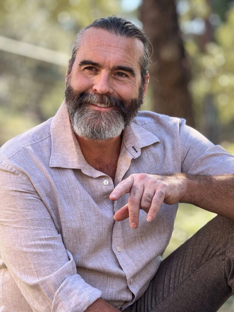 Dennis Hull in the park with a friendly inviting smile.