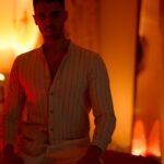 Nicholas in a cozy space lit by ambient lights.